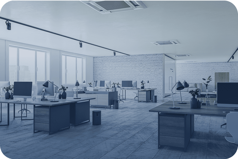 Modern open-plan office with desks and computers, bright and spacious.